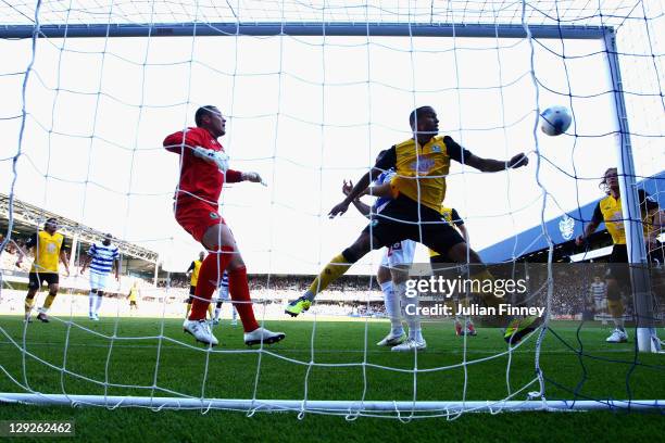 Paul Robinson and Martin Olsson of Blackburn Rovers watch the shot by Heidar Helguson of Queens Park Rangers loop over them and into the goal during...