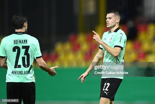 Laszlo Benes of Borussia Monchengladbach celebrates with teammate Jonas Hofmann after scoring their team's second goal during the DFB Cup second...