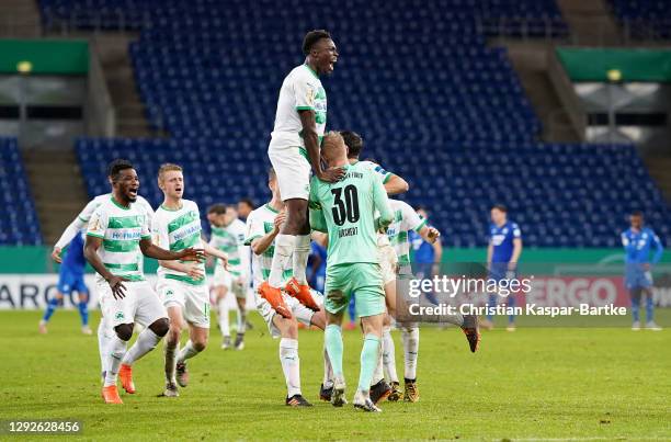 Marco Meyerhofer and Sascha Burchert of SpVgg Greuther Furth celebrate with teammates after victory in the penalty shootout of the DFB Cup second...