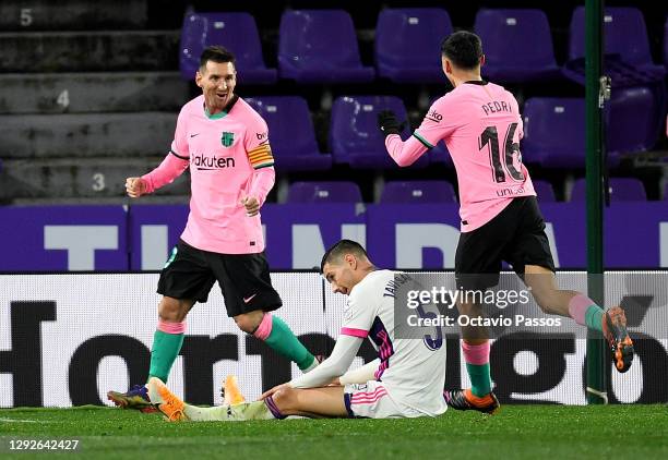 Lionel Messi of Barcelona celebrates with Pedri after scoring his sides third goal as Javier Sanchez of Real Valladolid reacts during the La Liga...