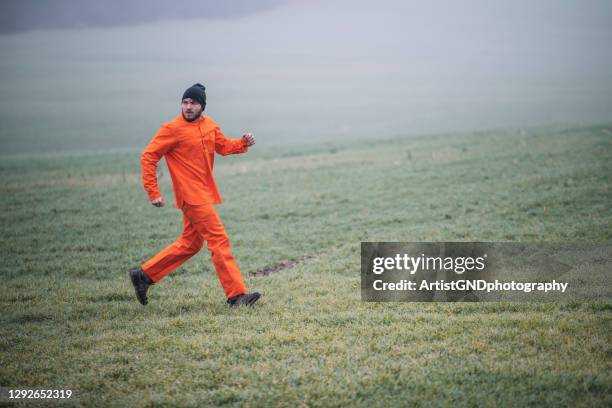 prisoner running from the jail, prison break. - prison escape stock pictures, royalty-free photos & images