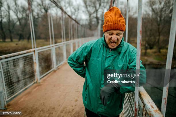 senior man resting after jogging - dyspnea stock pictures, royalty-free photos & images