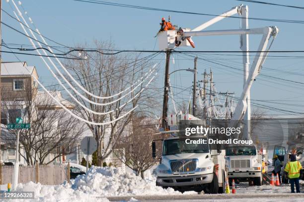 work crews fixing power lines after a storm. - power line truck stock pictures, royalty-free photos & images