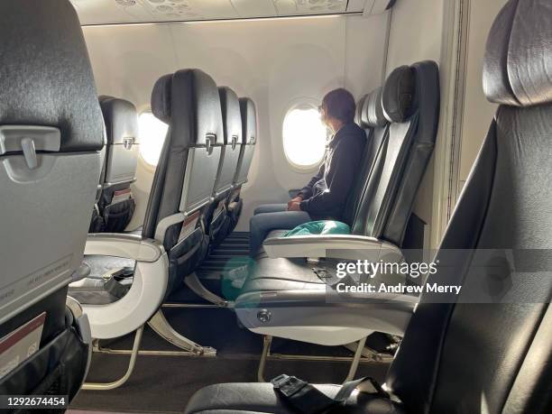 air travel during coronavirus pandemic, empty airplane seats - aisle seat airline stock-fotos und bilder
