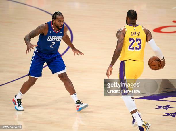 Kawhi Leonard of the LA Clippers guards LeBron James of the Los Angeles Lakers during the season opening game at Staples Center on December 22, 2020...