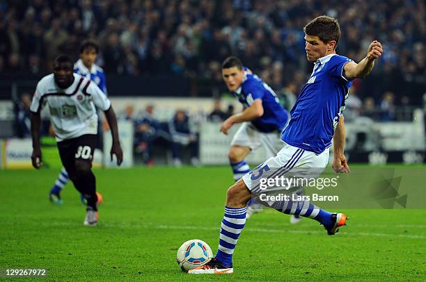 Klaas Jan Huntelaar of Schalke scores his teams first goal during the Bundesliga match between FC Schalke 04 and 1. FC Kaiserslautern at Veltins...