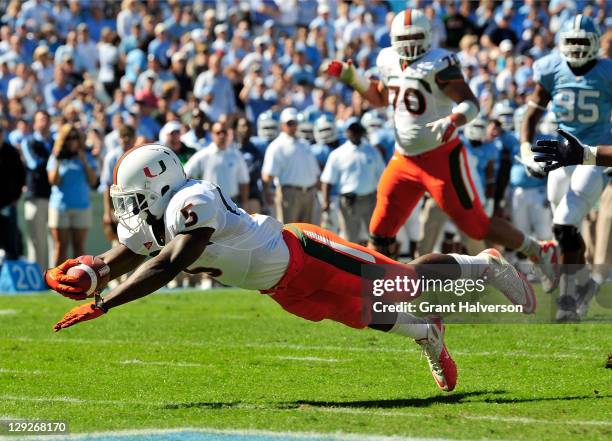 Mike James of the Miami Hurricanes dives into the end zone for a touchdown against the North Carolina Tar Heels at Kenan Stadium on October 15, 2011...