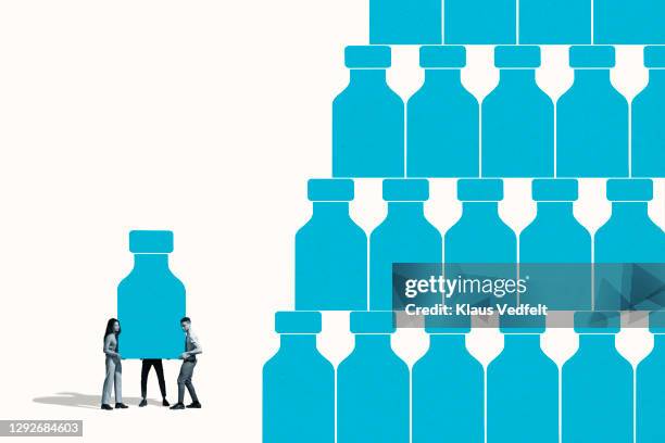 man and women making pyramid with blue pill bottle - shape color identity series bildbanksfoton och bilder