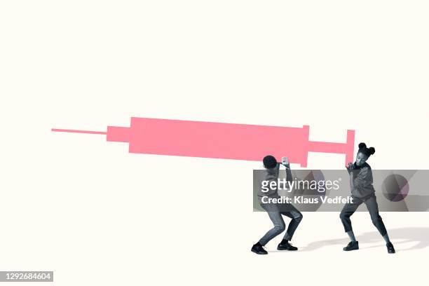 man and woman carrying large heavy injection - man studio shot stock pictures, royalty-free photos & images