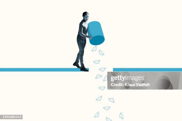 woman throwing disposable masks from garbage bin - vuilnisbak stockfoto's en -beelden