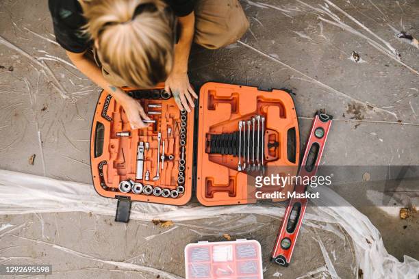 high angle view of woman with toolbox over concrete land - verktygslåda bildbanksfoton och bilder