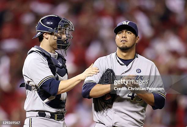 Catcher Jonathan Lucroy of the Milwaukee Brewers talks with starting pitcher Yovani Gallardo during Game Three of the National League Championship...