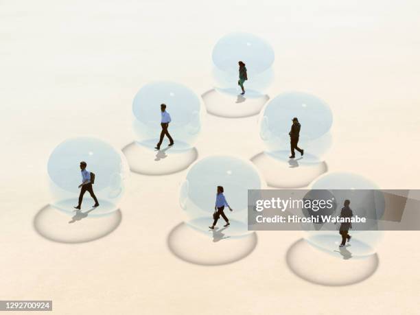 social distancing. people walking through the square in a transparent sphere. - nueva-normalidad-concepto fotografías e imágenes de stock