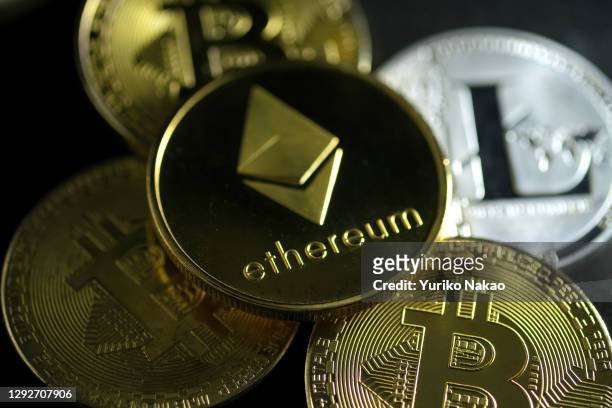 In this photo illustration, visual representations of digital cryptocurrencies, Ethereum, Bitcoin and Litecoin, are arranged on December 17, 2020 in...