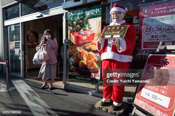 Woman leaves a KFC restaurant on December 23, 2020 in Tokyo, Japan. KFC at Christmas has become something of a tradition in Japan with some...
