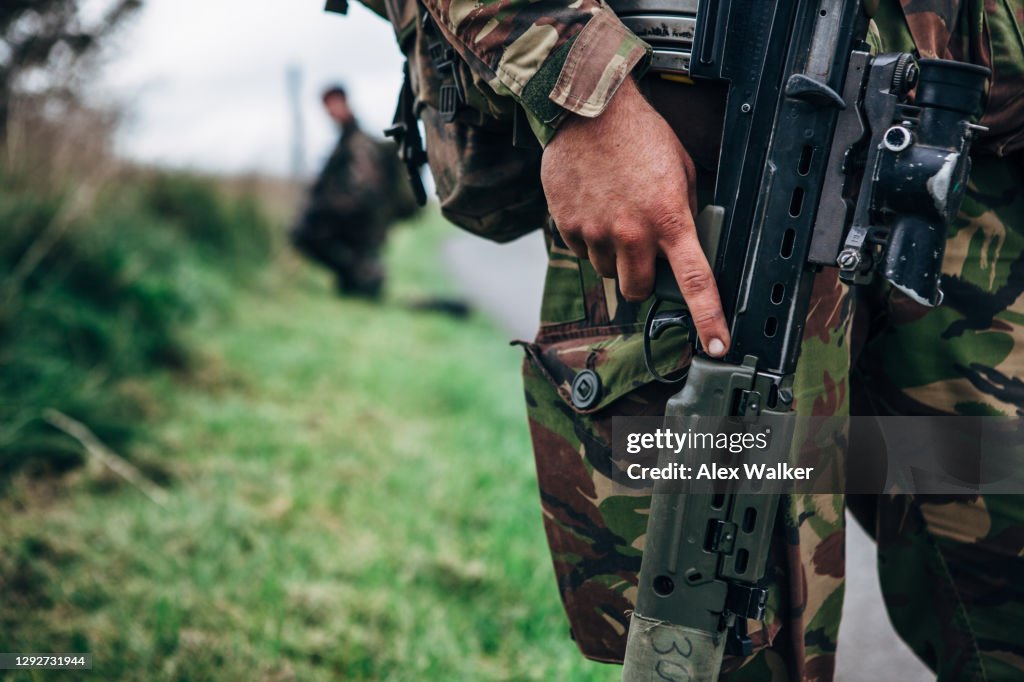Close up of soldier holding assault rifle
