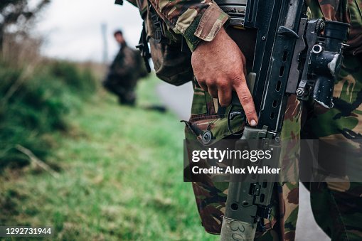 Close up of soldier holding assault rifle Close up of soldier holding assault rifle