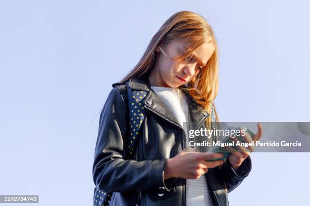 angry girl watching the video on the phone - teen angel stock pictures, royalty-free photos & images
