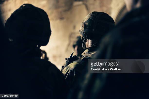 a group of soldiers in silhouette from rear. - royal marines stock-fotos und bilder