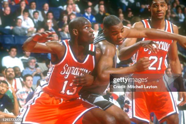 Conrad McRae of the Syracuse Orange and Othella Harrington of the Georgetown Hoyas fight for position during a college basketball game at Capital...