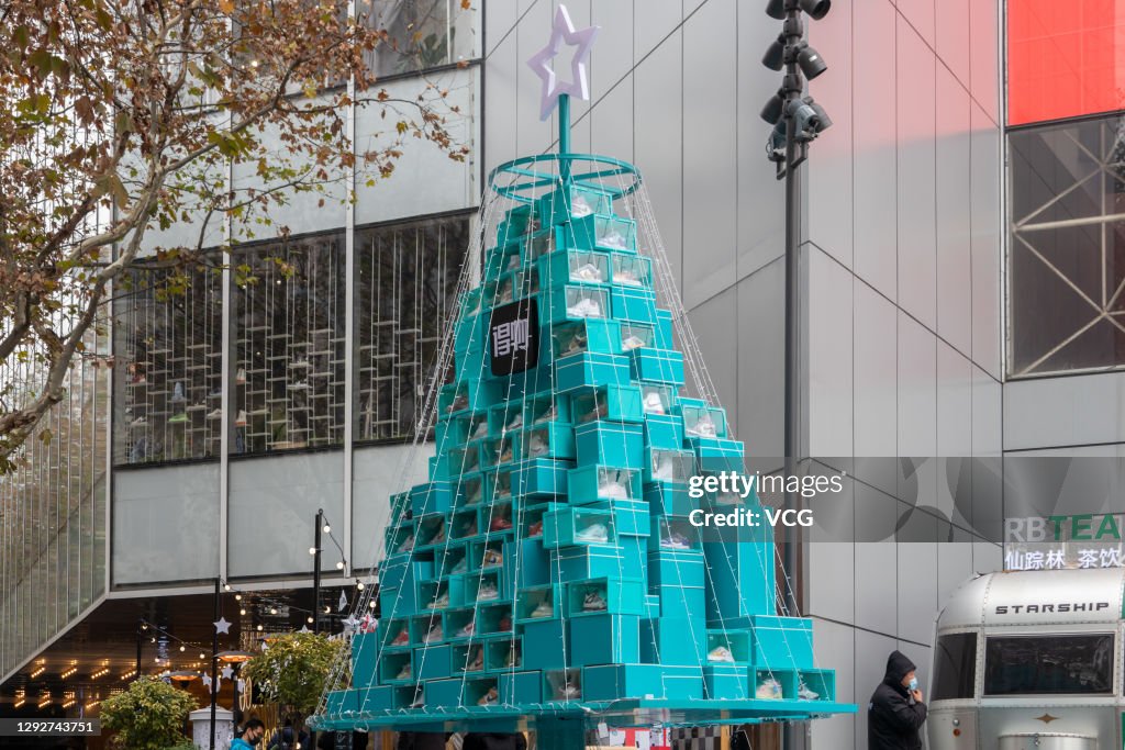 A Christmas tree made up of boxes of Nike shoes is seen at a