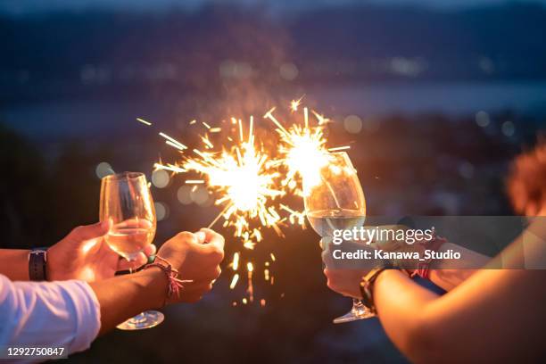 new year's eve celebration with sparklers and wine - new year imagens e fotografias de stock