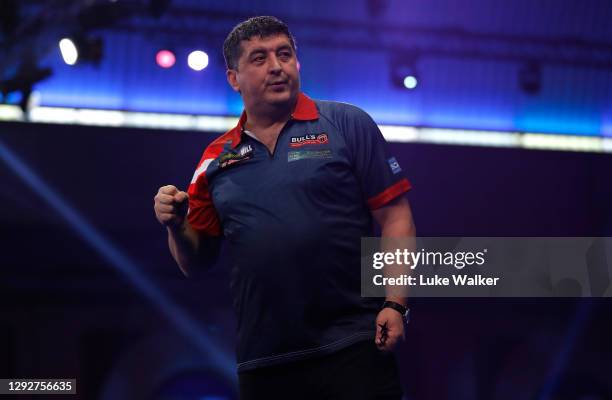 Mensur Suljović of Serbia reacts during his second round match against Matthew Edgar of England during day nine of the PDC William Hill World Darts...