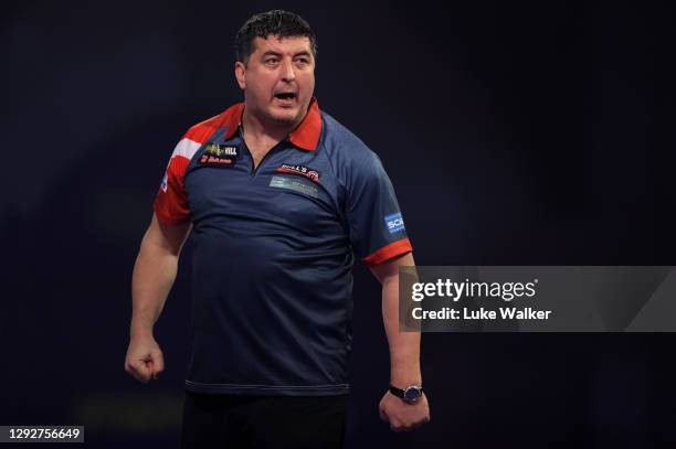 Mensur Suljović of Serbia reacts during his second round match against Matthew Edgar of England during day nine of the PDC William Hill World Darts...