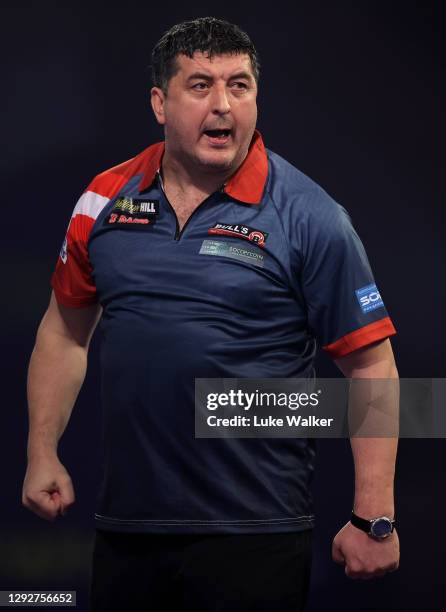 Mensur Suljović of Serbia reacts during his second round match against Matthew Edgar of England during day nine of the PDC William Hill World Darts...