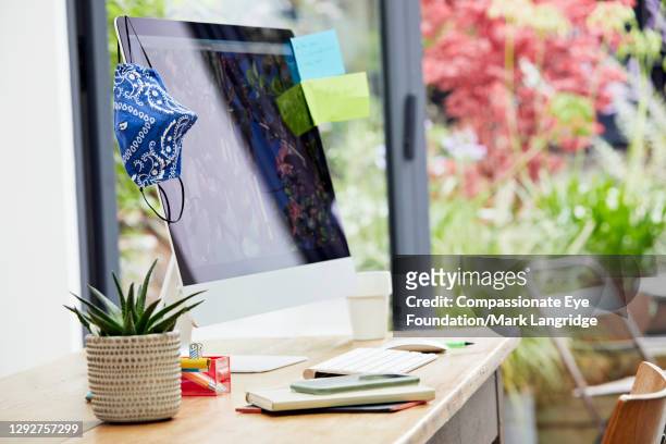 desk in home office with face mask - computer wearing eye mask stock pictures, royalty-free photos & images