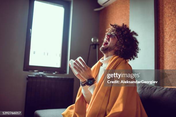 male sick with covid-19 sneezing hard and wiping nose - mucus stock pictures, royalty-free photos & images