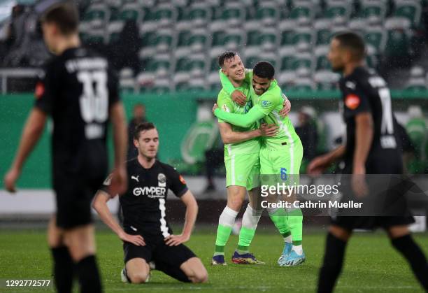Yannick Gerhardt of Vfl Wolfsburg celebrates with team mate Paulo Otavio Rosa Silva after scoring their sides first goal during the DFB Cup second...