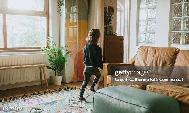 little girl approaches a glass interior doorway - leaving room stock pictures, royalty-free photos & images