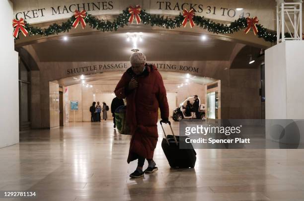 People walk through Grand Central Terminal two days before the Christmas holiday on December 23, 2020 in New York City. Grand Central Terminal, one...