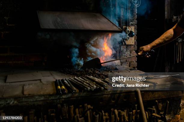 lighting a forge fire. heavy smoke development - blacksmith shop stock pictures, royalty-free photos & images