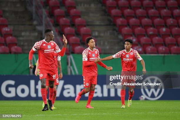 Jean-Paul Boetius of 1. FSV Mainz 05 celebrates with Leandro Barreiro and team mates after scoring their sides first goal during the DFB Cup second...