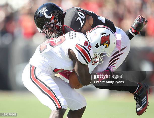 Chris Williams of the Cincinnati Bearcats tackles Eli Rogers of the Louisville Cardinals during the game at Paul Brown Stadium on October 15, 2011 in...