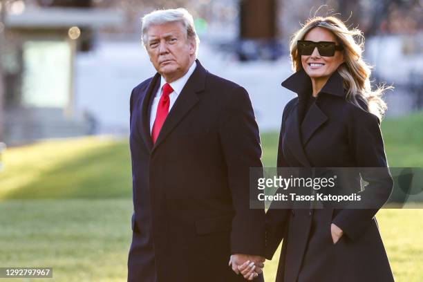 President Donald Trump and first lady Melania Trump walk on the south lawn of the White House on December 23, 2020 in Washington, DC. The Trumps are...