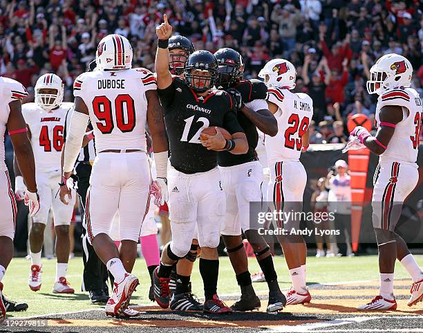 Zach Collaros of the Cincinnati Bearcats celebrates a touchdown during the game against the Louisville Cardinals at Paul Brown Stadium at Paul Brown...