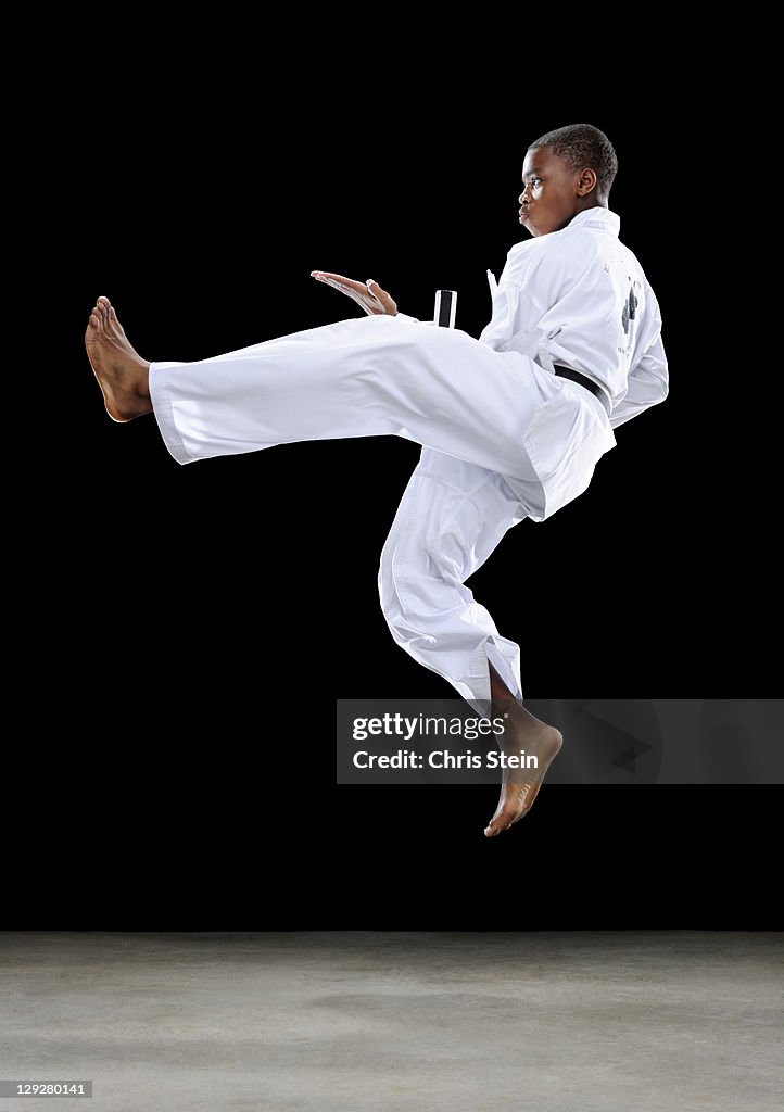 Boy doing a jump front kick