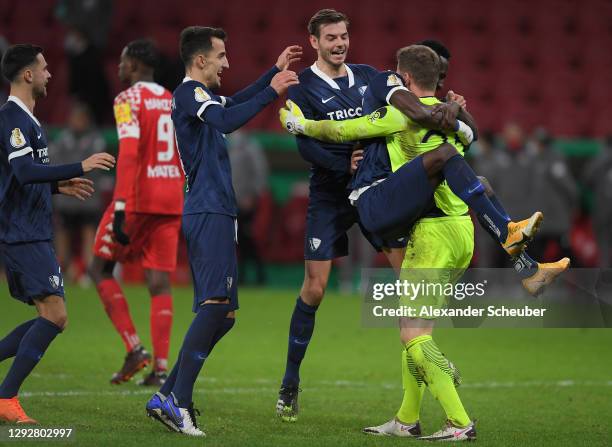 Patrick Drewes of VfL Bochum celebrates victory with team mates Maxim Leitsch and Armel Bella-Kotchap after a penalty shoot out in the DFB Cup second...