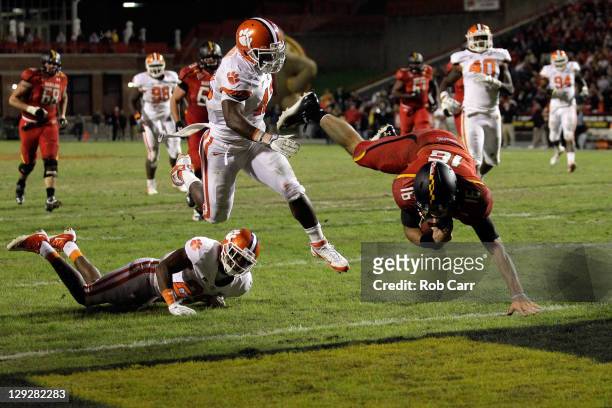 Quarterback C.J. Brown of the Maryland Terrapins dives into the endzone for a touchdown in front of the Clemson Tigers defense during the first half...
