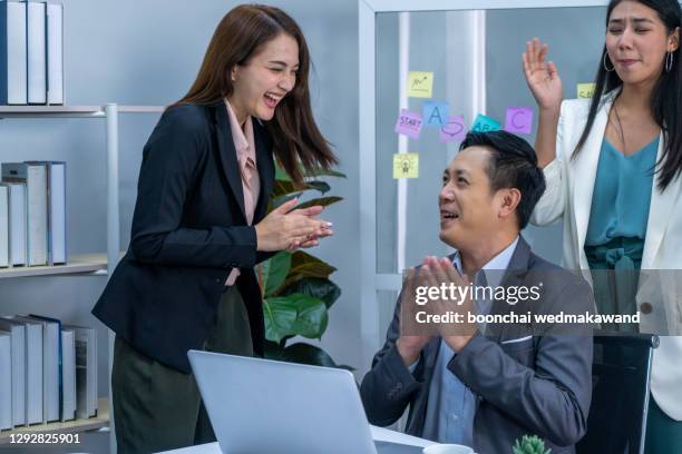 business team applauding their colleague in the office - employee award stock pictures, royalty-free photos & images