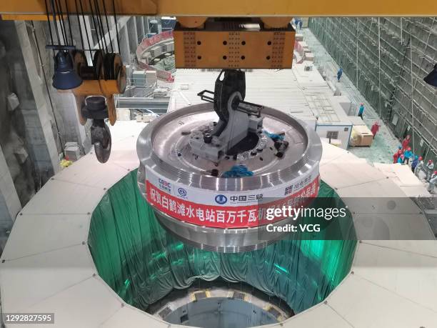 The runner of No.16 1,000-megawatt turbine is lifted at the world's second-largest hydropower station Baihetan on December 23, 2020 in Zhaotong,...