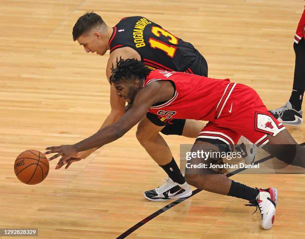 Patrick Williams of the Chicago Bulls and Bogdan Bogdanovic of the Atlanta Hawks battle for the ball at United Center on December 23, 2020 in...