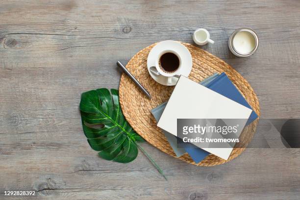 empty open page note book and coffee cup on wooden table top. - coffee table books stockfoto's en -beelden
