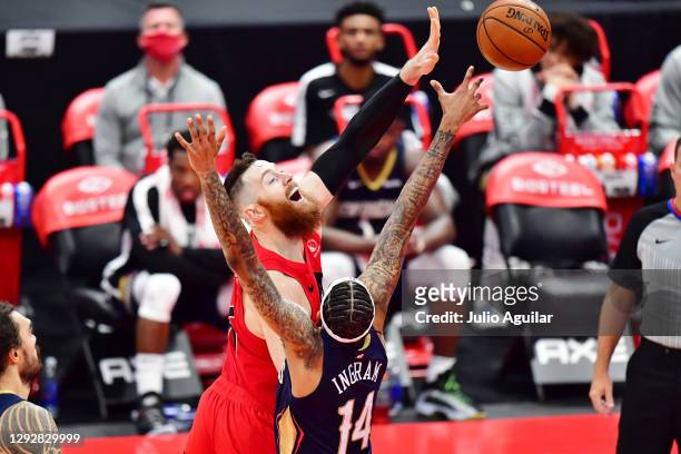 Aron Baynes of the Toronto Raptors shoots the ball against Brandon Ingram of the New Orleans Pelicans during the second half of a game at Amalie...