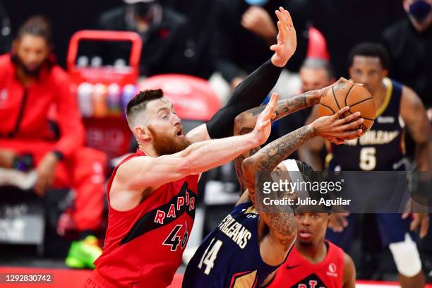 Brandon Ingram of the New Orleans Pelicans shoots against Aron Baynes of the Toronto Raptors during the second half at Amalie Arena on December 23,...
