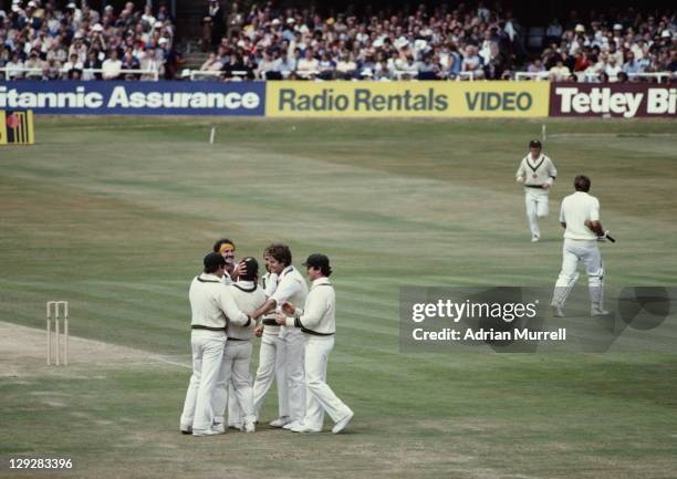 Dennis Lillee of Australia congratulates team mate Rodney Marsh on his world record for wicket keeper catches after the dismissal of Ian Botham...