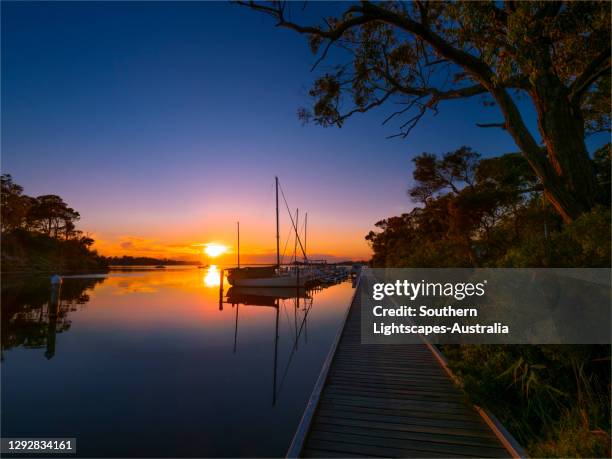a beautiful, serene and very colourful summer dawn at chinaman's creek, metung, gippsland lakes, victoria, australia. - gippsland lakes stock pictures, royalty-free photos & images